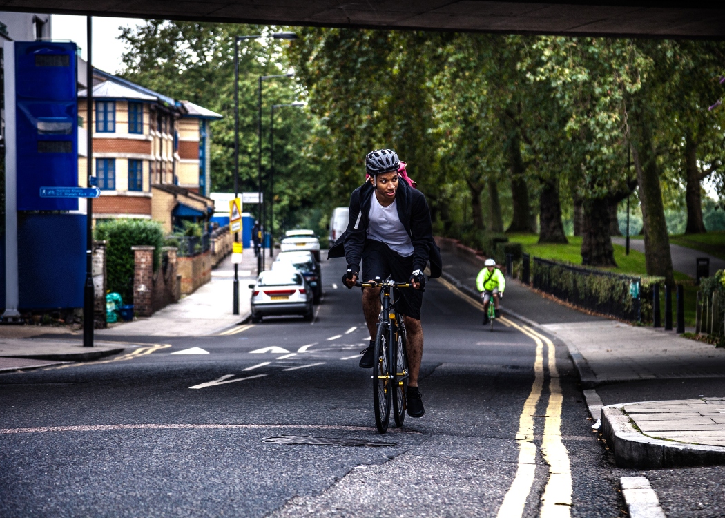 Man cycling to work in central London