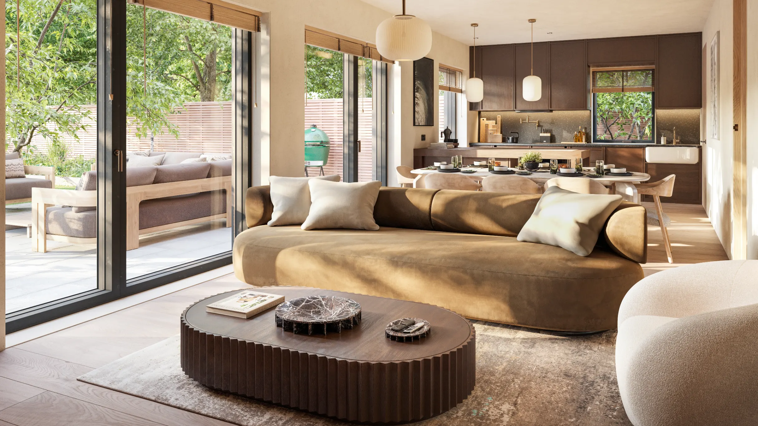 Living room with kitchen in the background. With tan sofa and brown coffee table, beige walls and brown kitchen cabinetry with large sliding doors to a garden