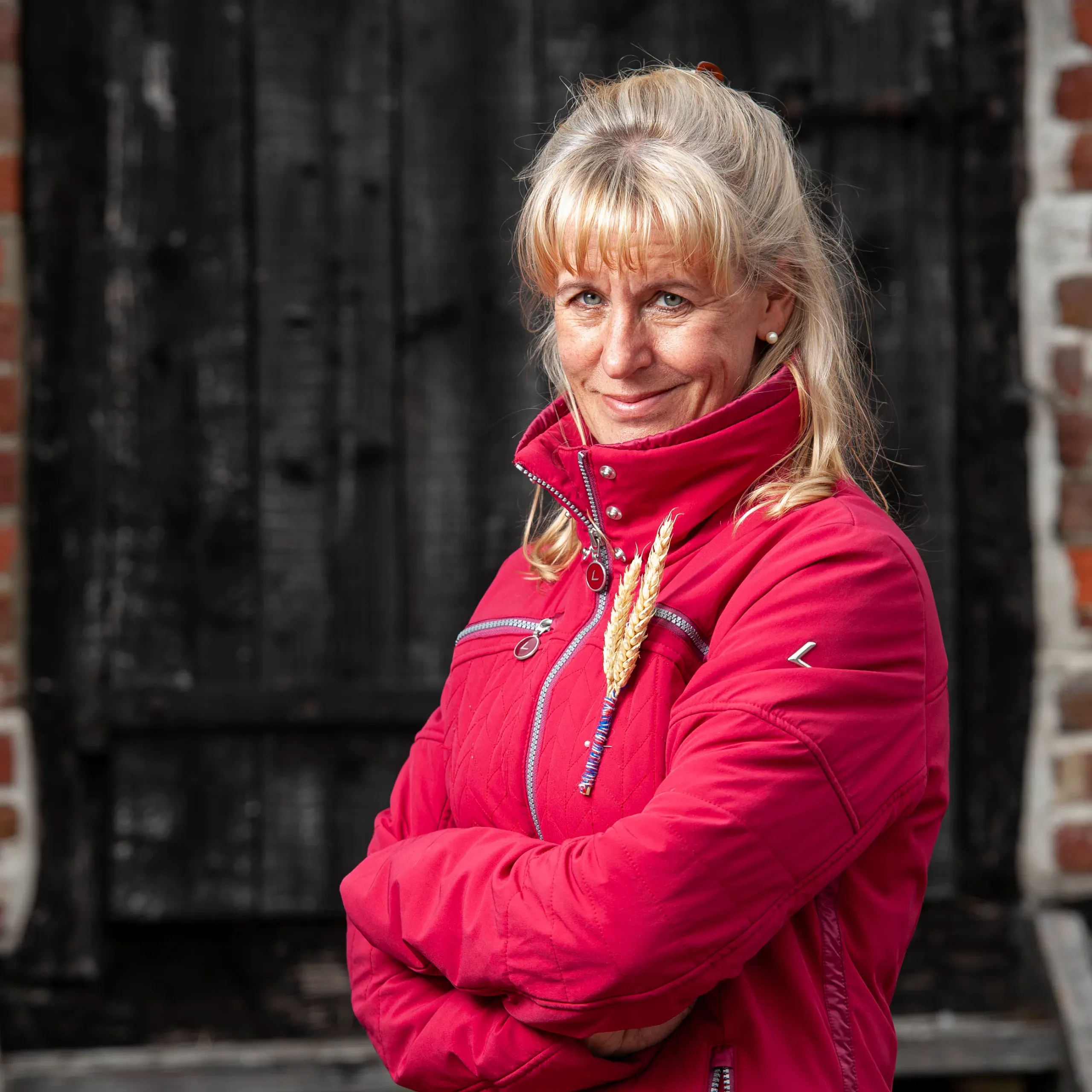 nfu-president-minette-batters-in-a-red-jacket-smiling-to-the-camera-outside-a-barn