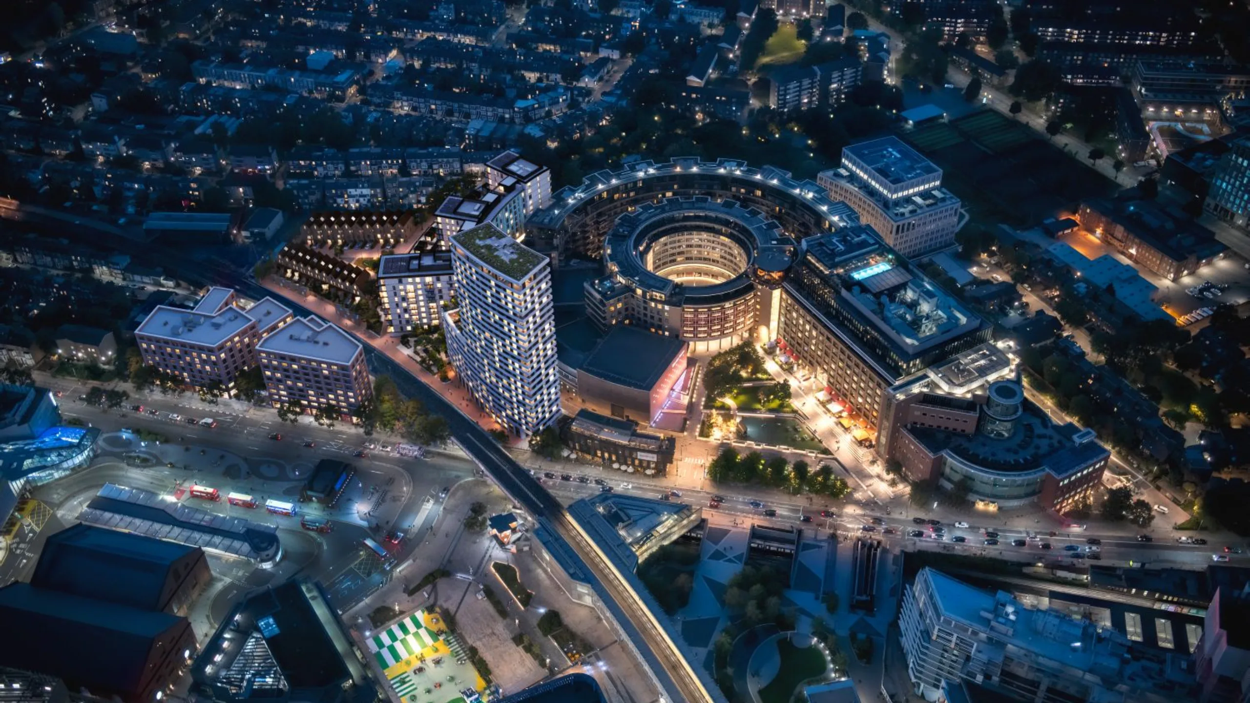 Ariel view at night of high rise buildings and streets filled with cars