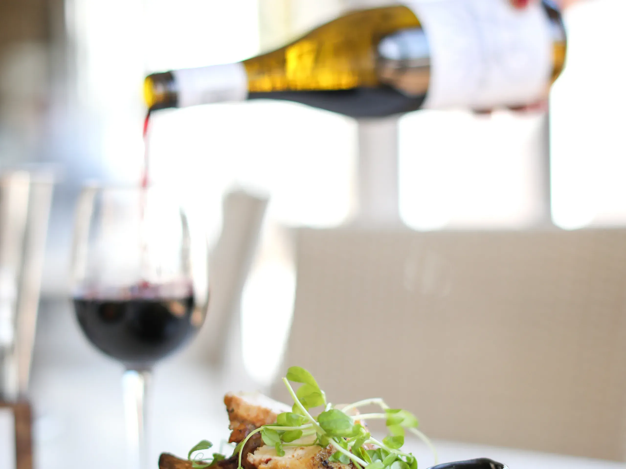 Wine being served with a meal in a restaurant. 