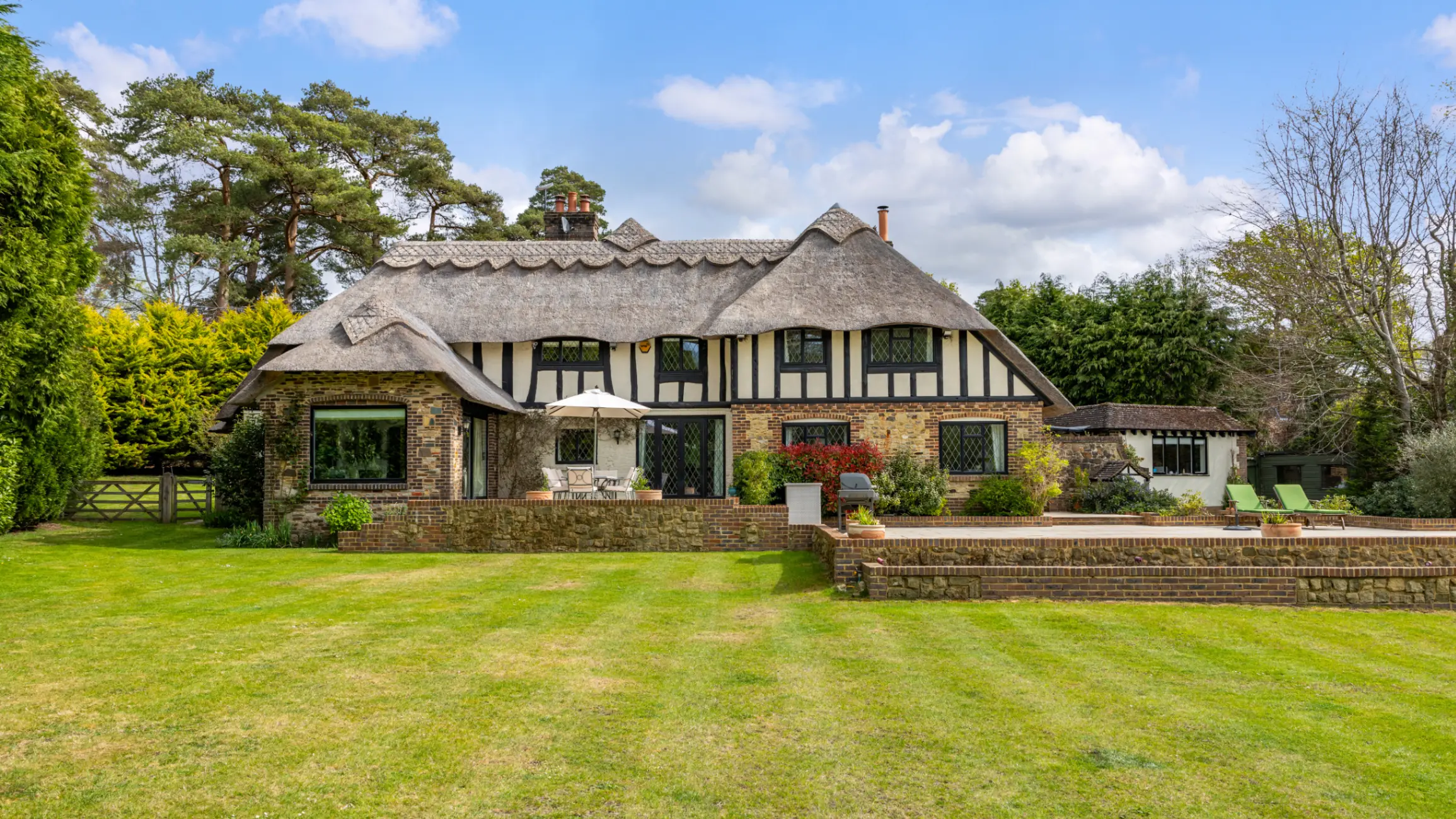 Exterior of arts and crafts cottage with a large front garden