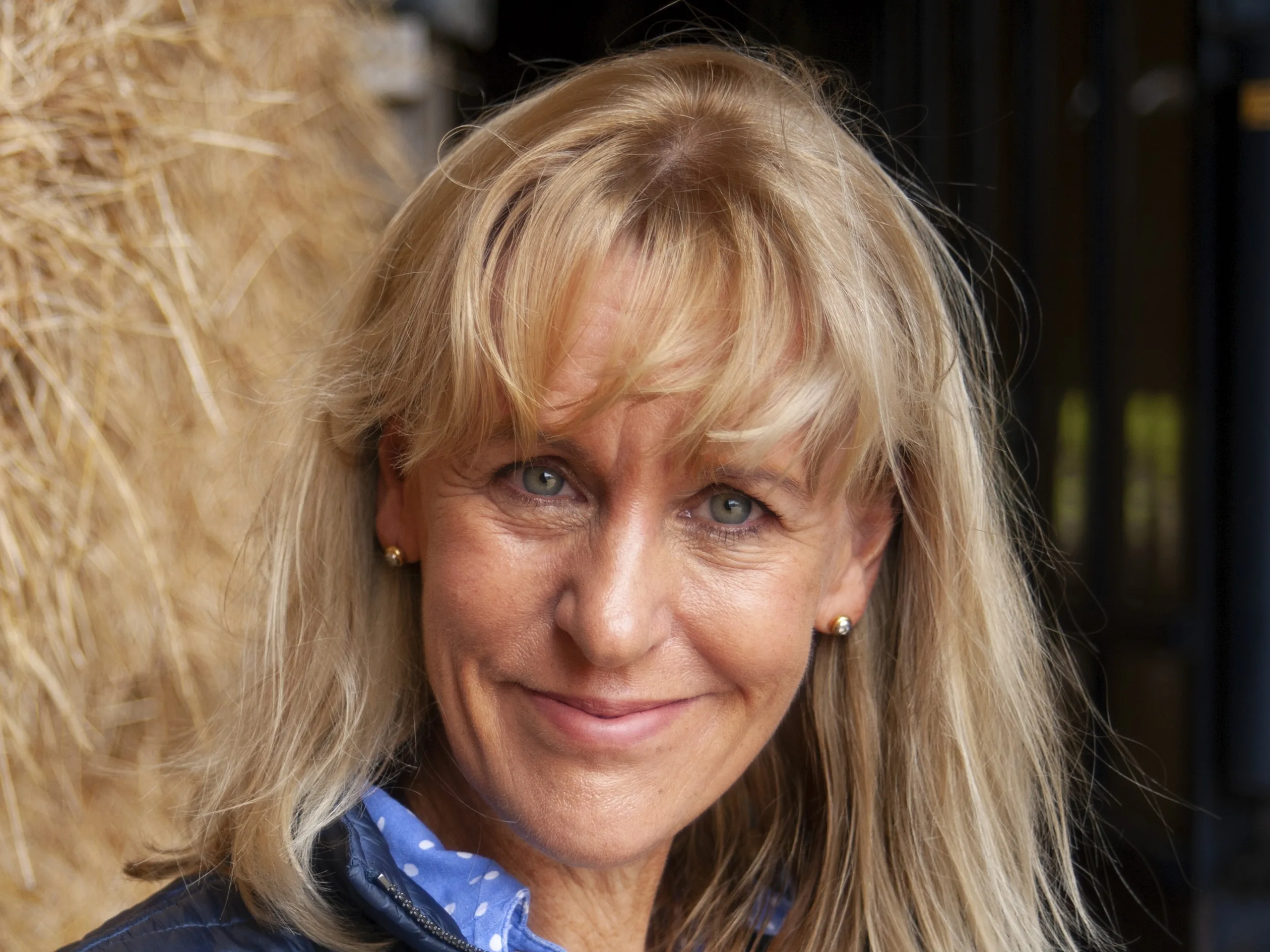 nfu-president-minette-batters-looking-and-smiling-to-camera-with-hay-in-the-background