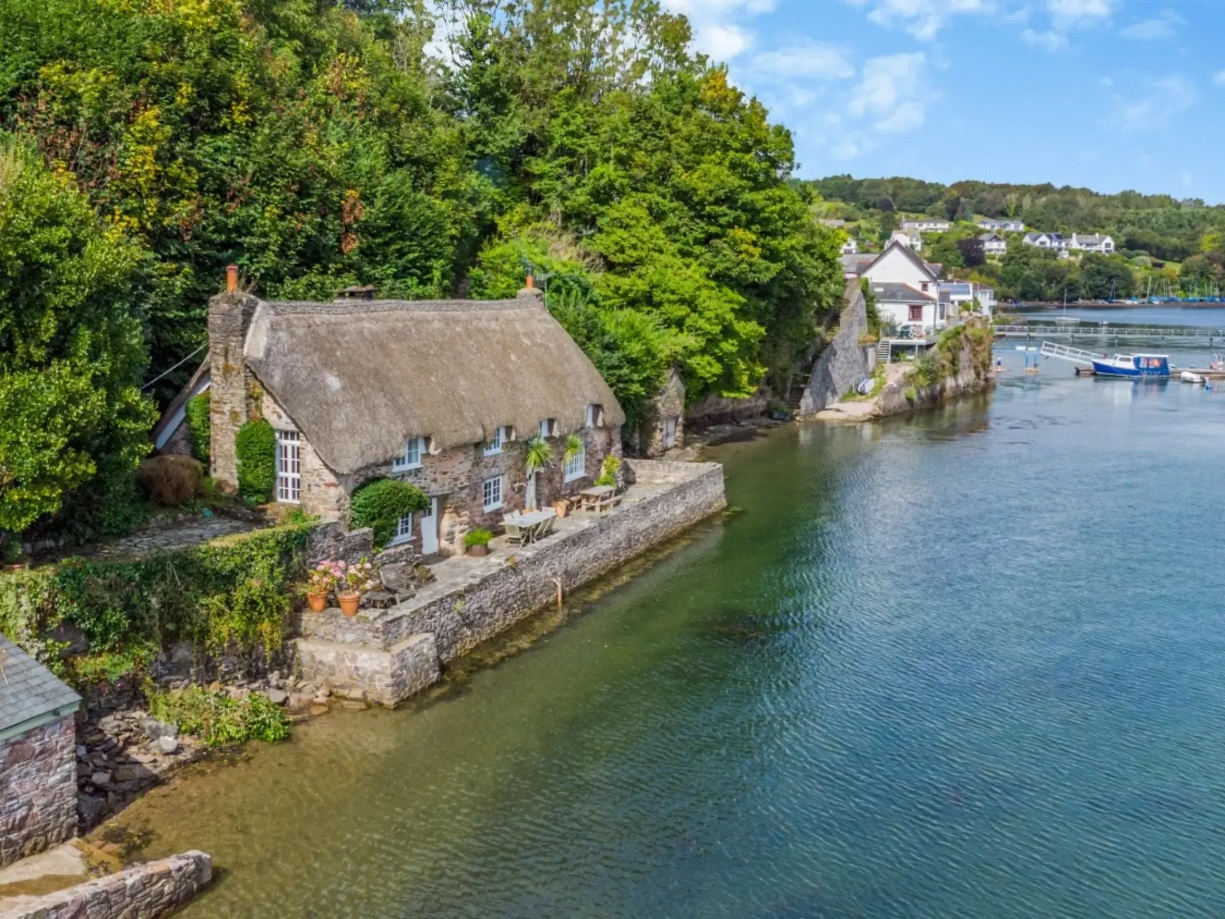 Exterior of thatched cottage on the banks of the River Dart