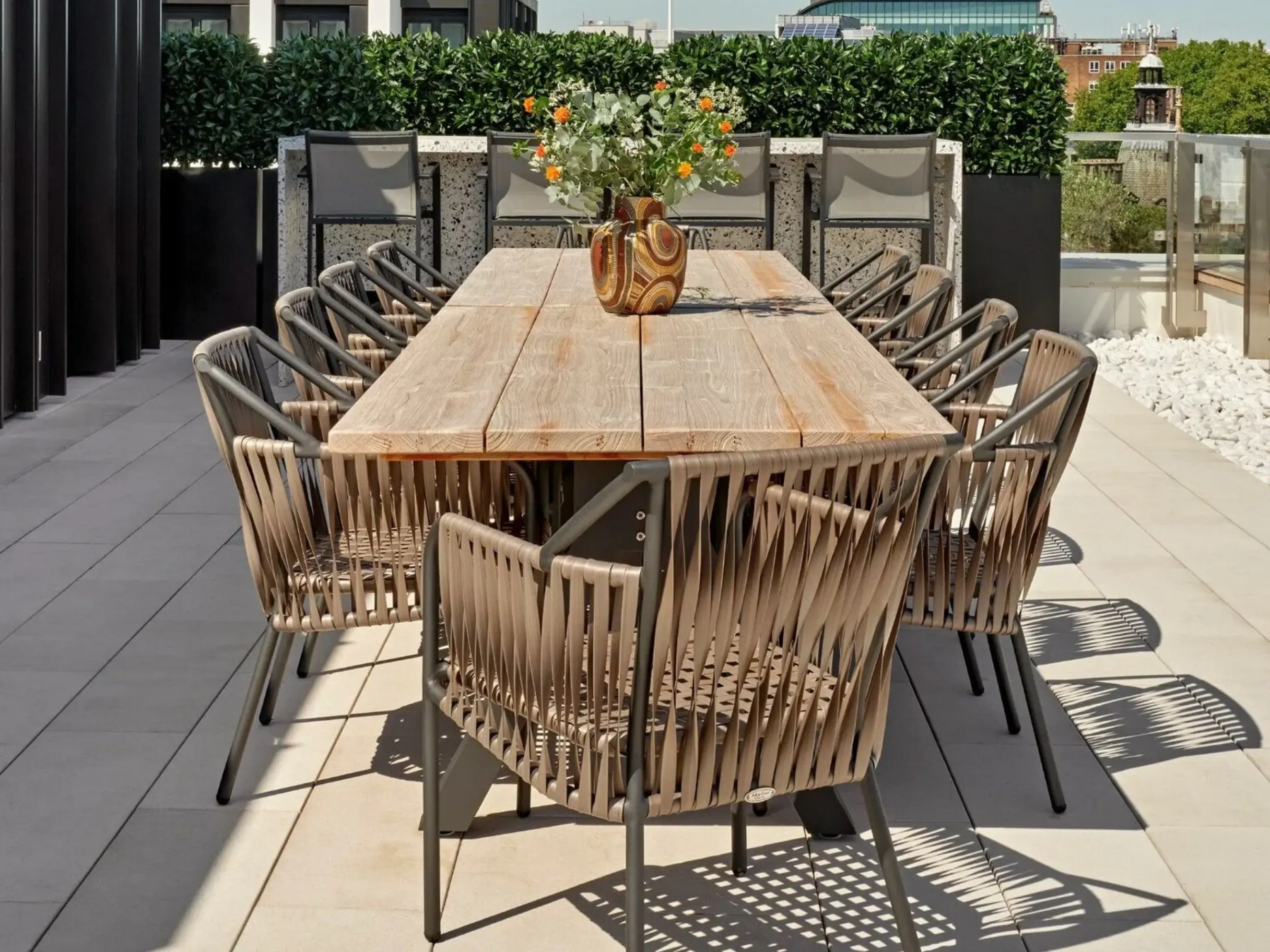 Wooden dining table and chairs on a garden terrace