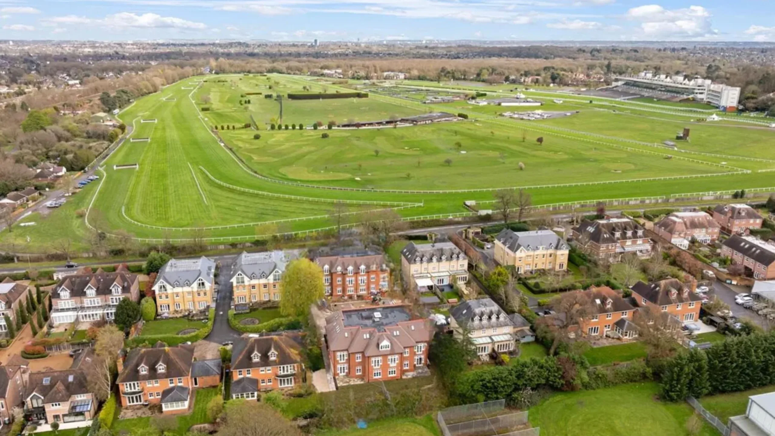 Ariel view of a racecourse next a row of houses