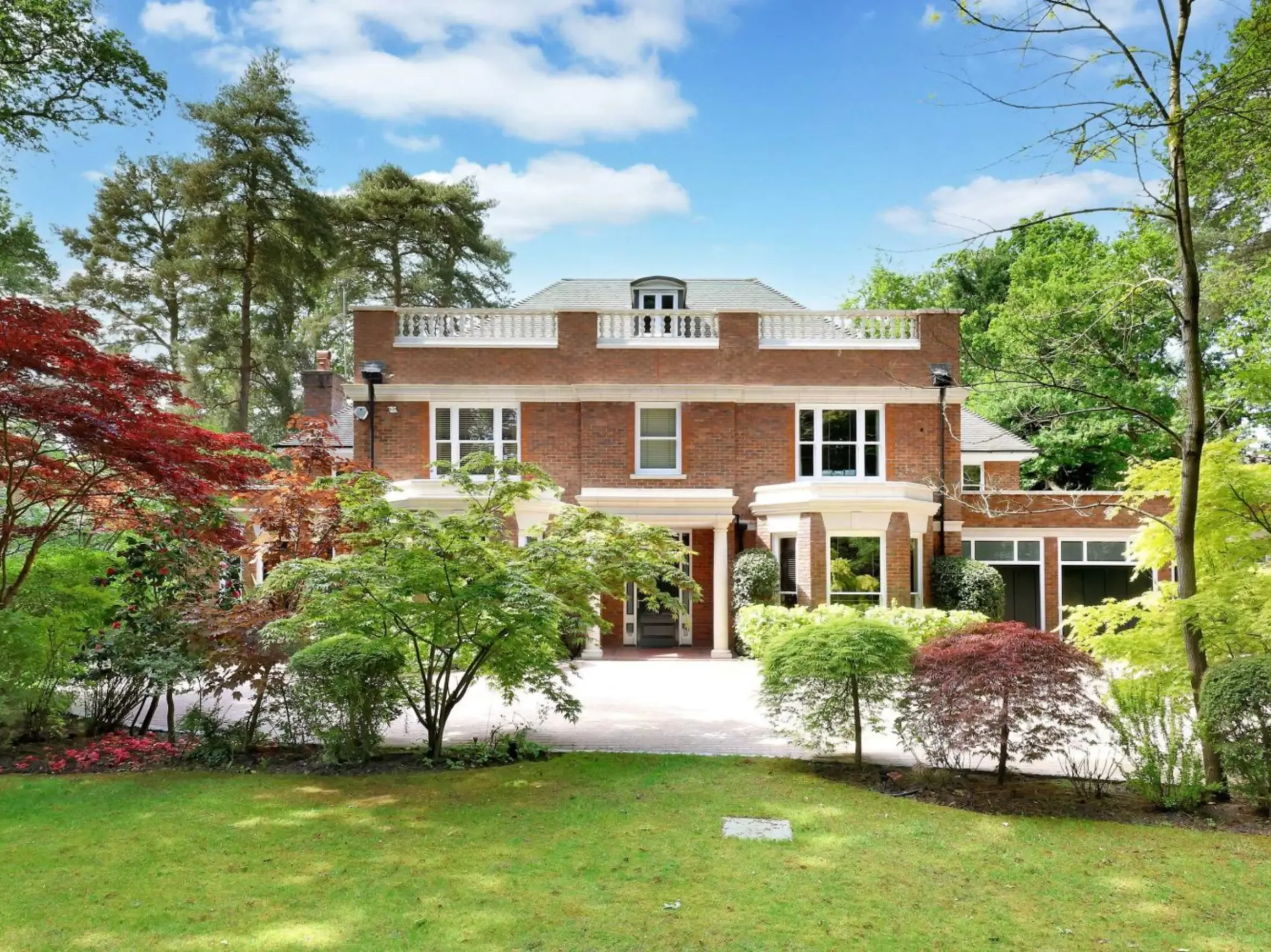 Exterior of country home with front garden filled with small trees