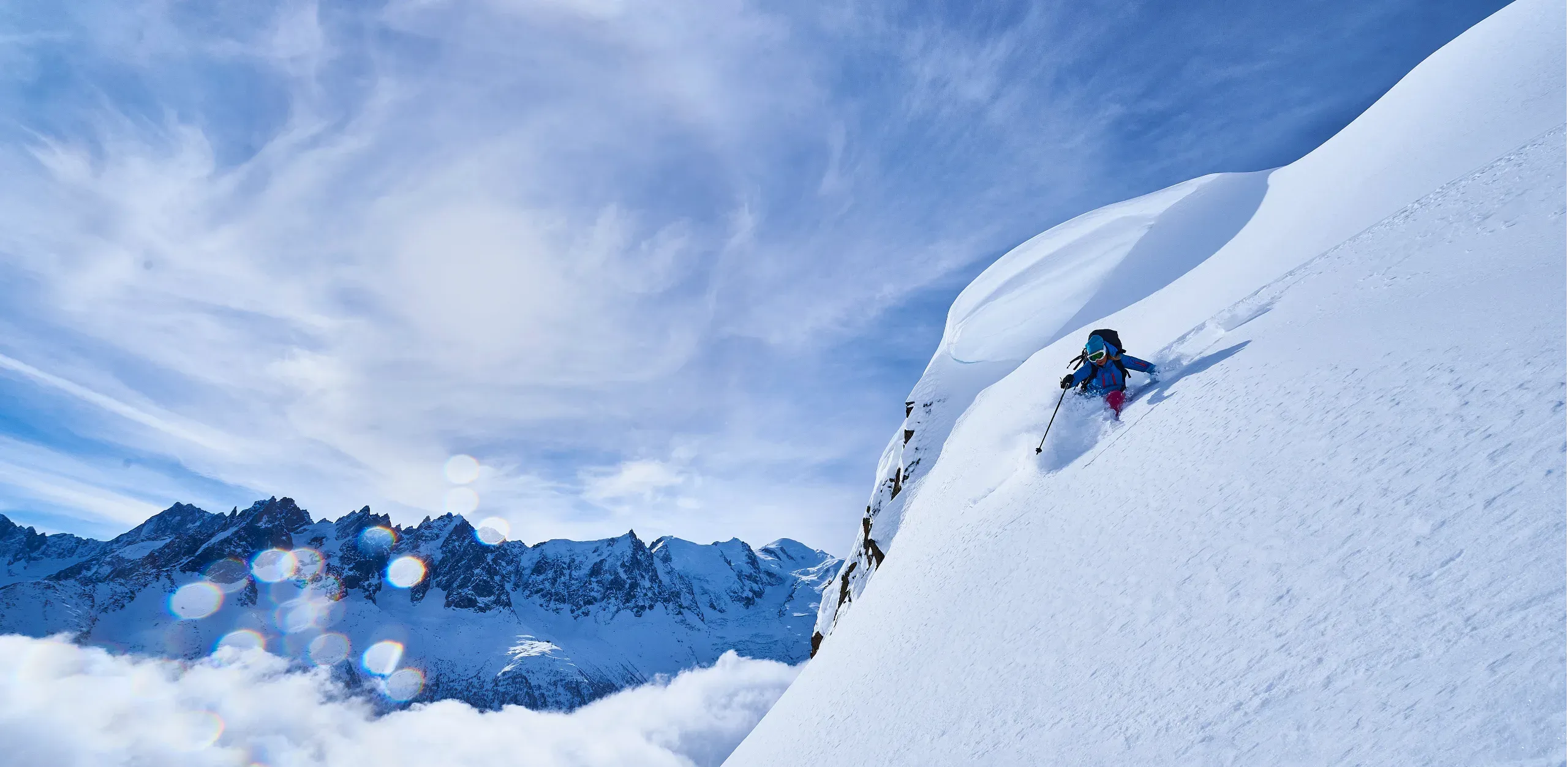 Woman skiing down steep mountainside in Swiss Alps, Gstaad, Switzerland