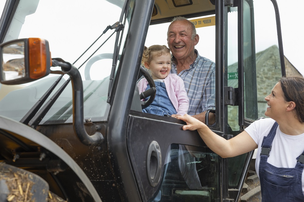 Three generations of a farming family on a tractor