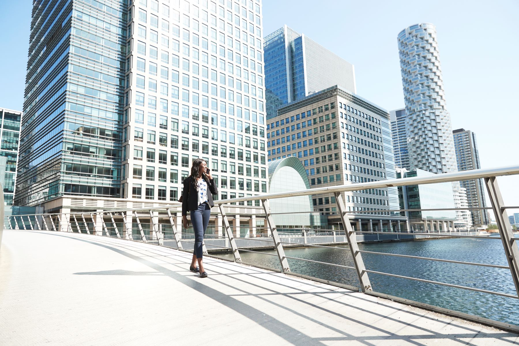 Woman talking on the phone while walking in Canary Wharf