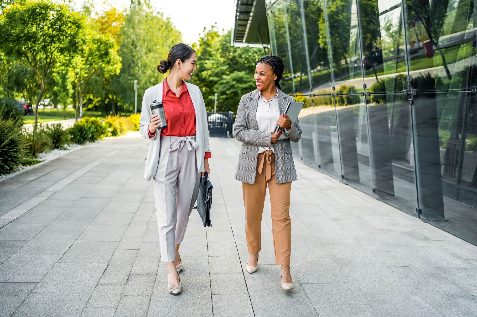 Two business people walking outside an office