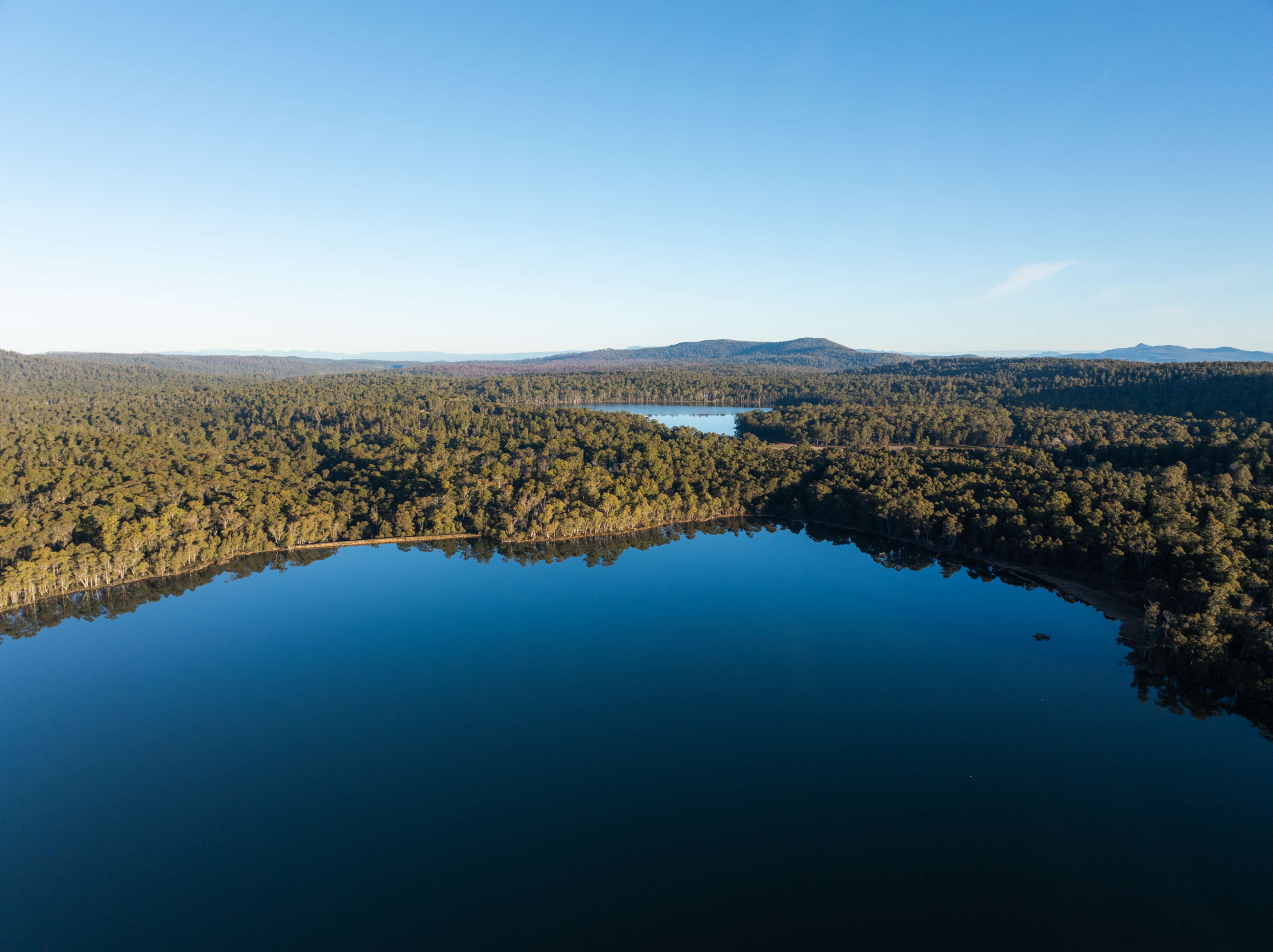 An overhead shot of an Australian lake in a countryside setting.
