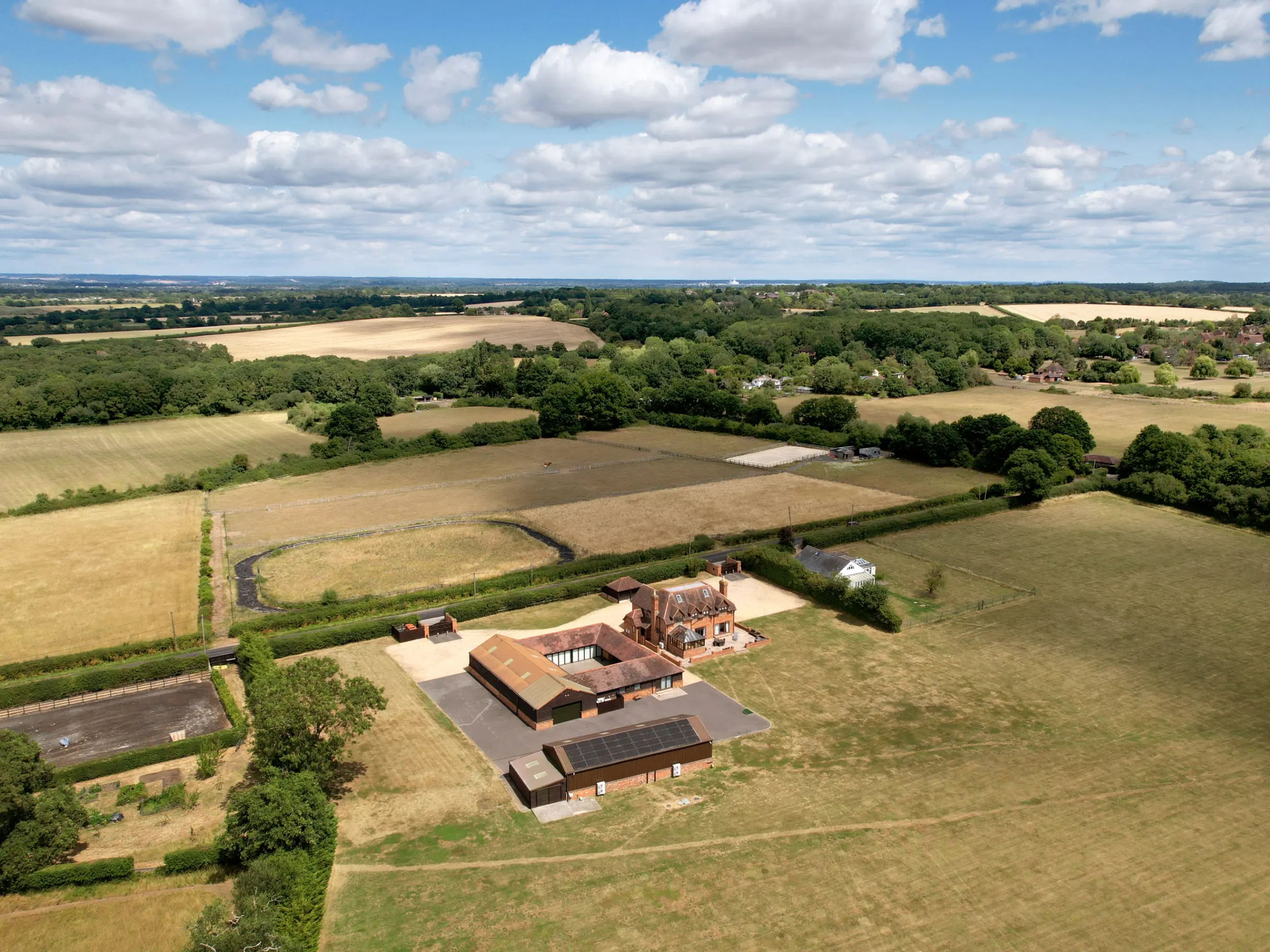 Ariel view of large farmhouse and surrounding fields 