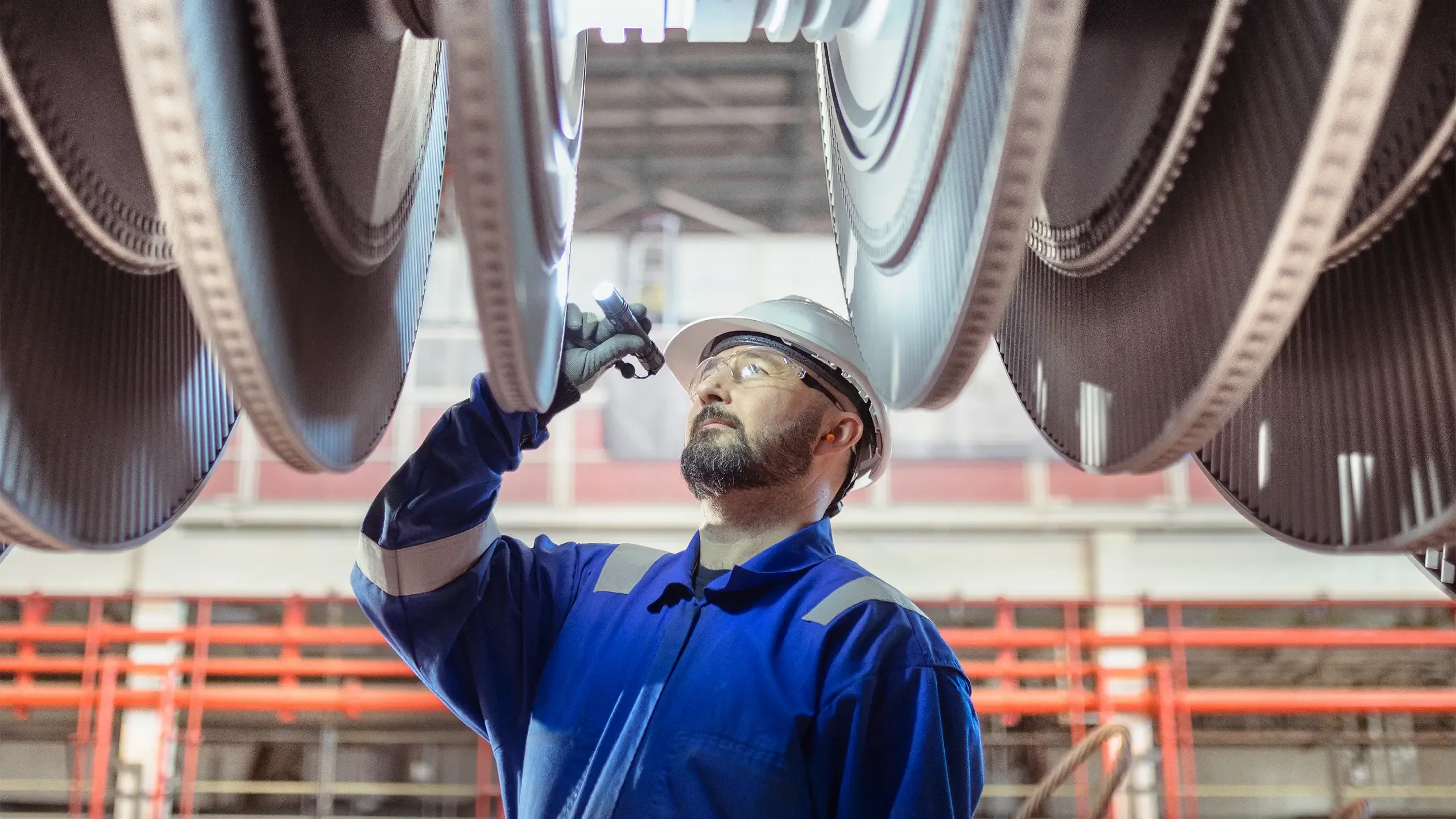 Engineer inspecting a turbine in a  nuclear power station.