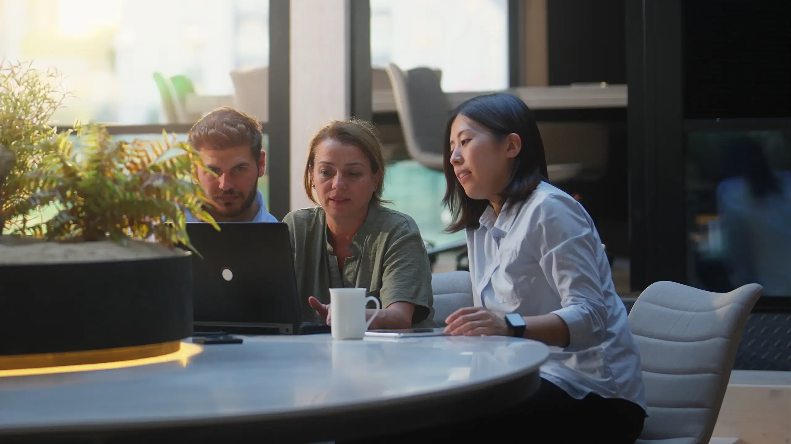 A group of business people are working together in a modern office working space.