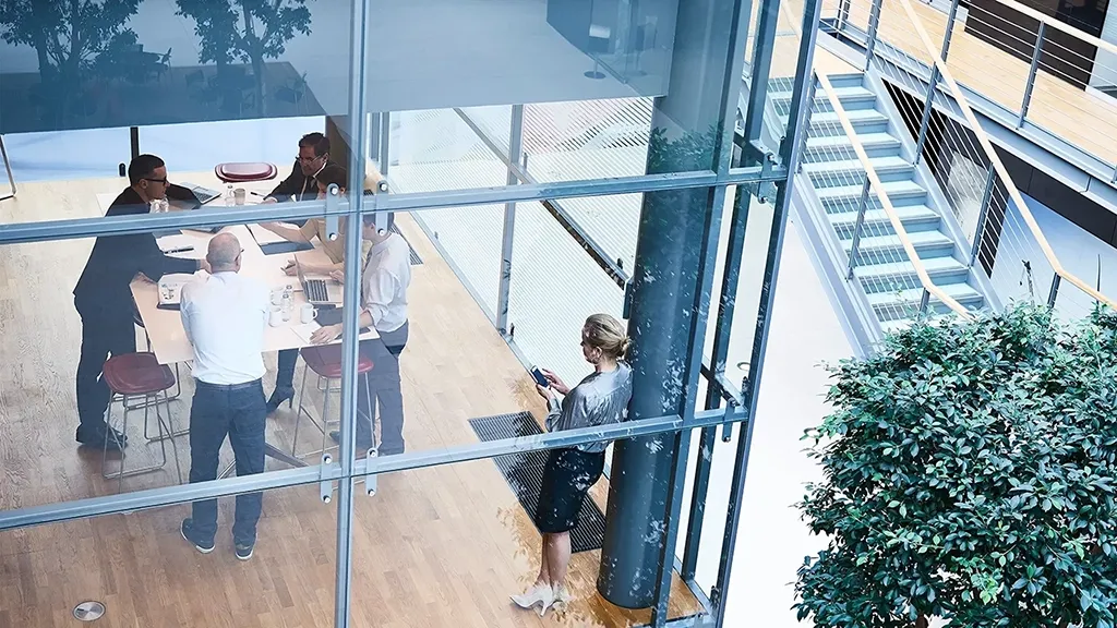 High angle view of businessmen and businesswomen meeting in conference room