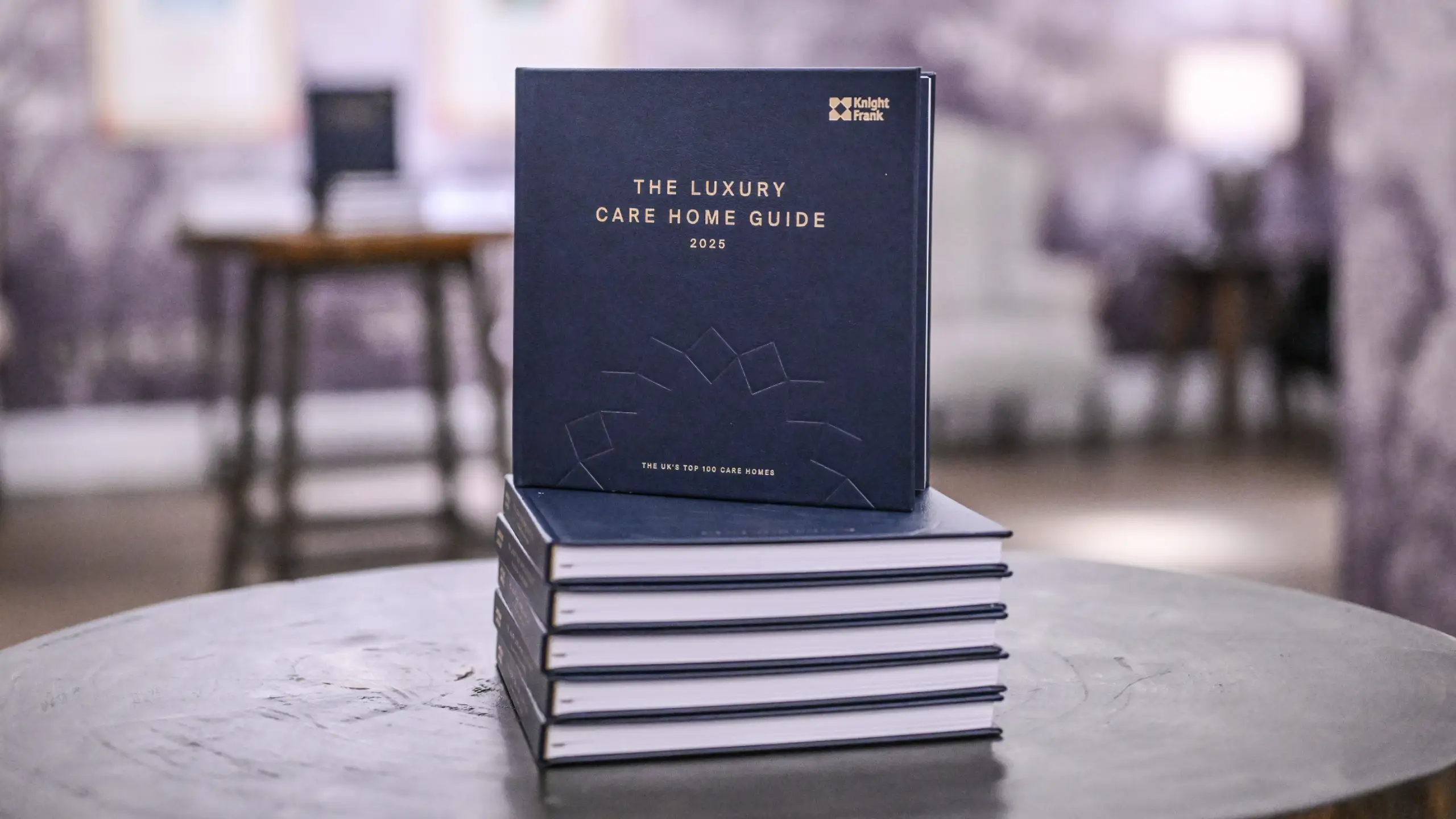 A stack of Luxury Care Home Guides 2025