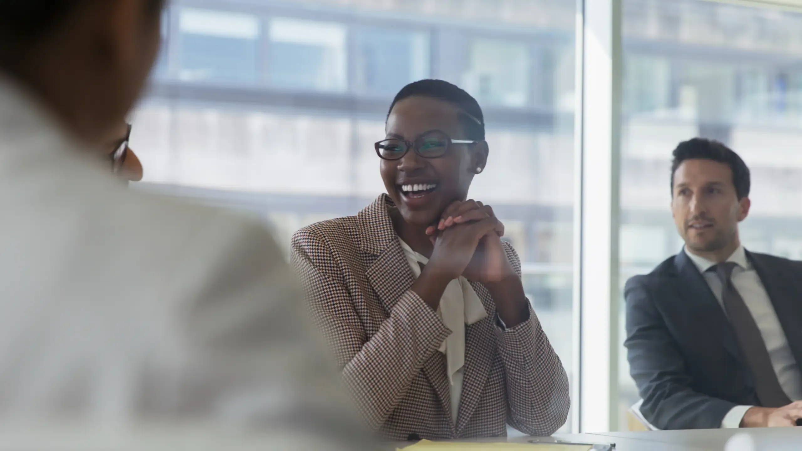 Laughing businesswoman in conference room meeting