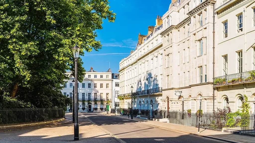 White stucco townhouses overlooking a leafy Georgian square in the heart of London, UK.
