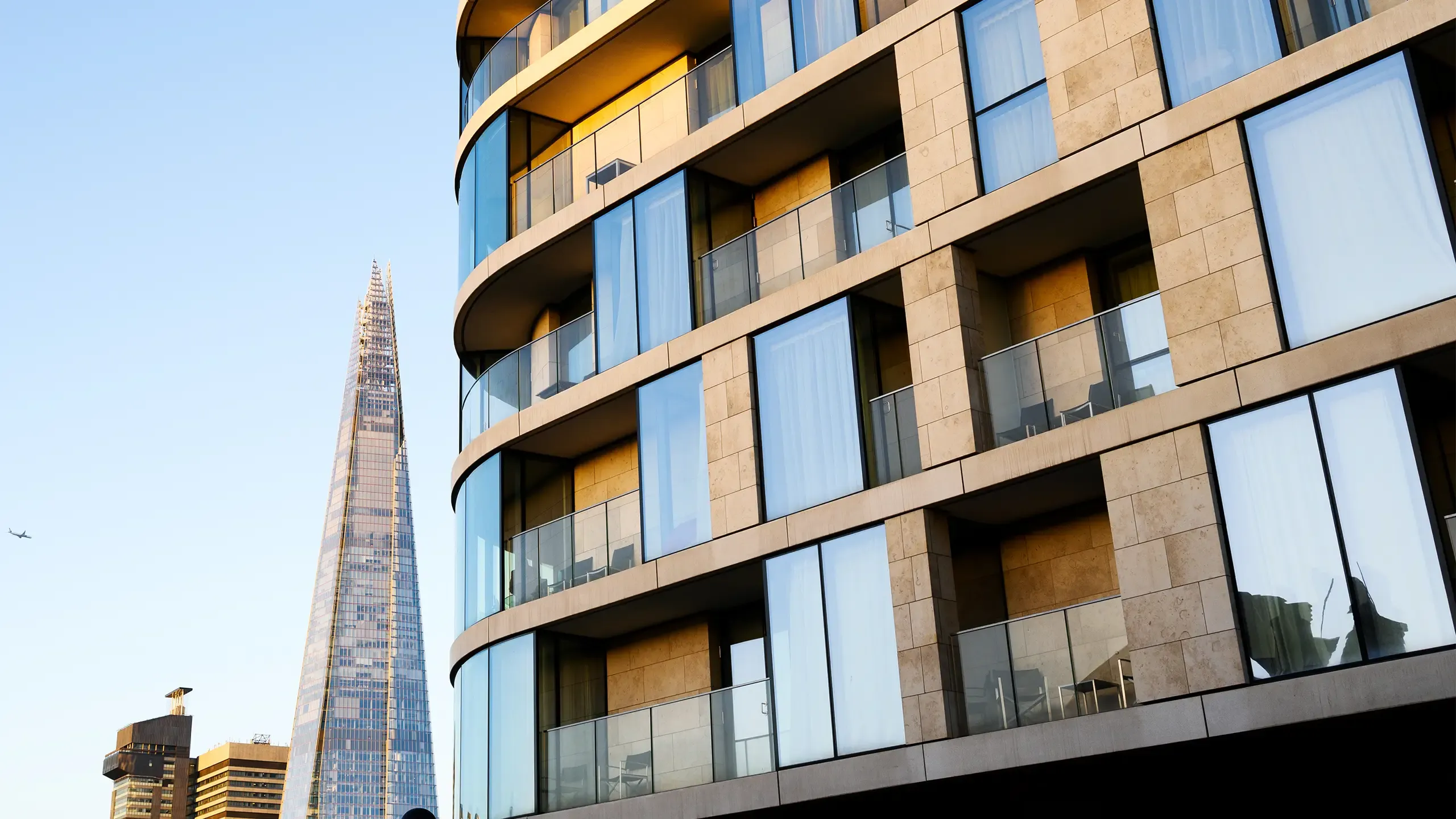 UK, modern contemporary apartment building in central London with view of the Shard at sunrise
