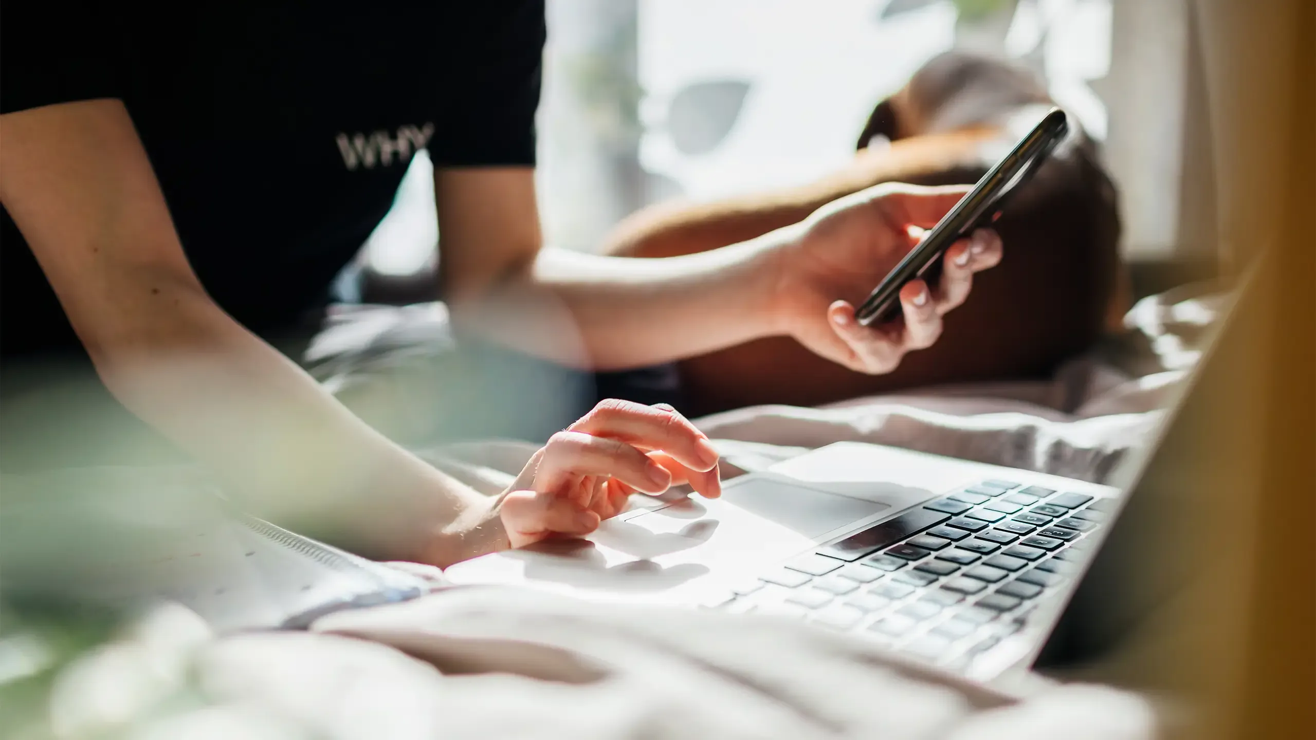 A teenage girl logging into an online zoom class using her laptop to study from her bedroom at home.