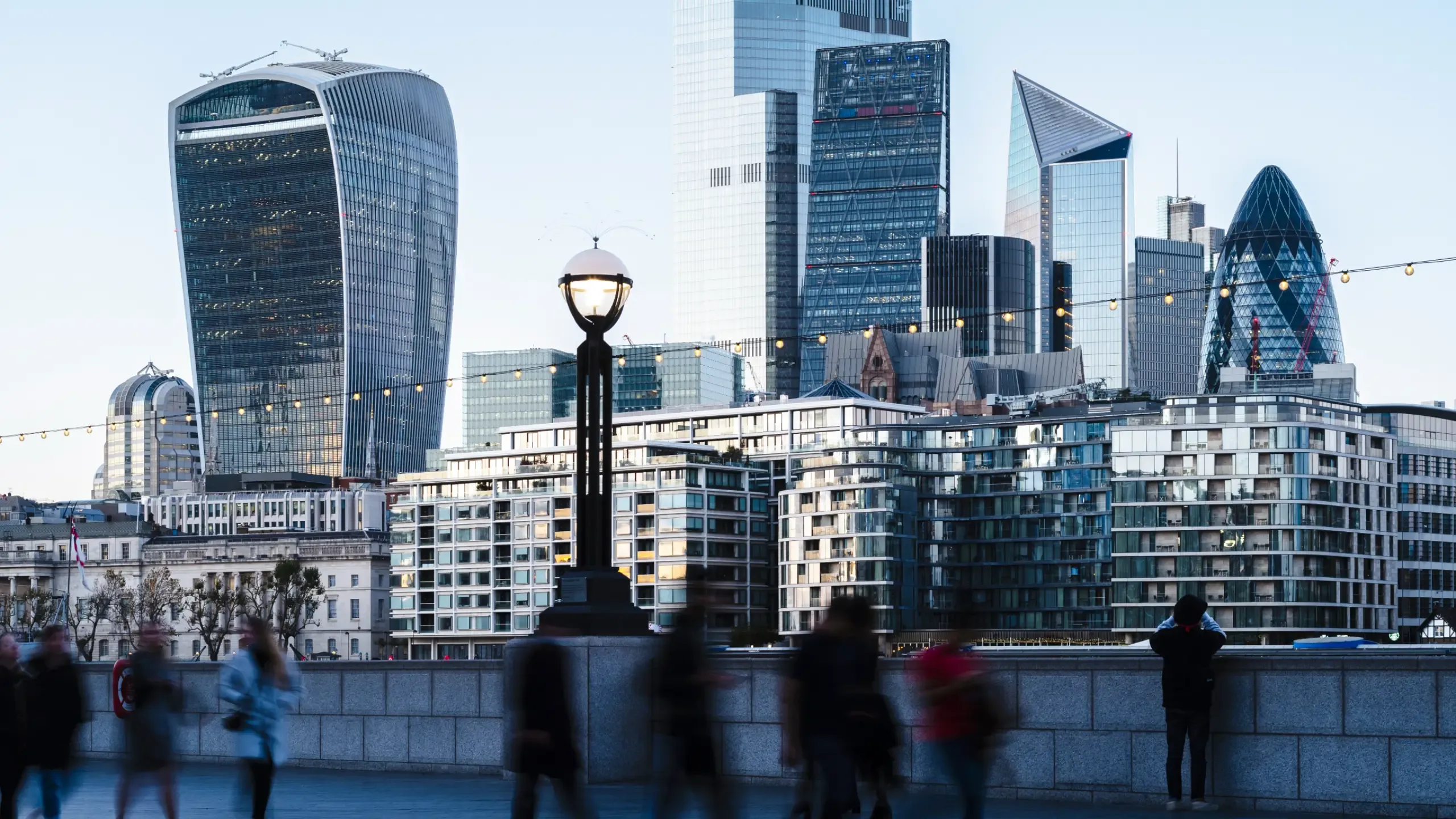 View towards the skyline of the City of London from the Thames Path at dusk