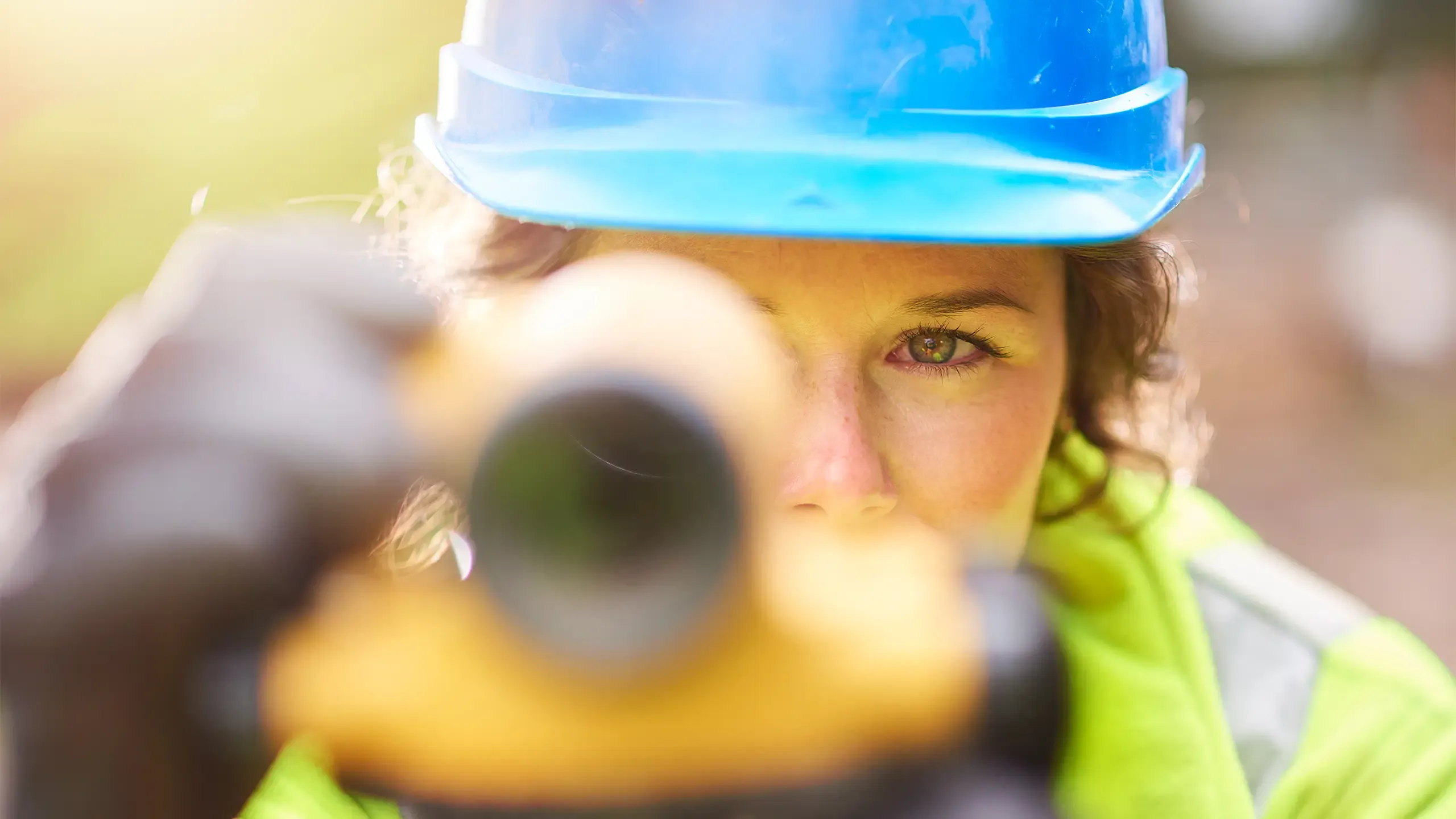 A young female surveyor checking her levels on site