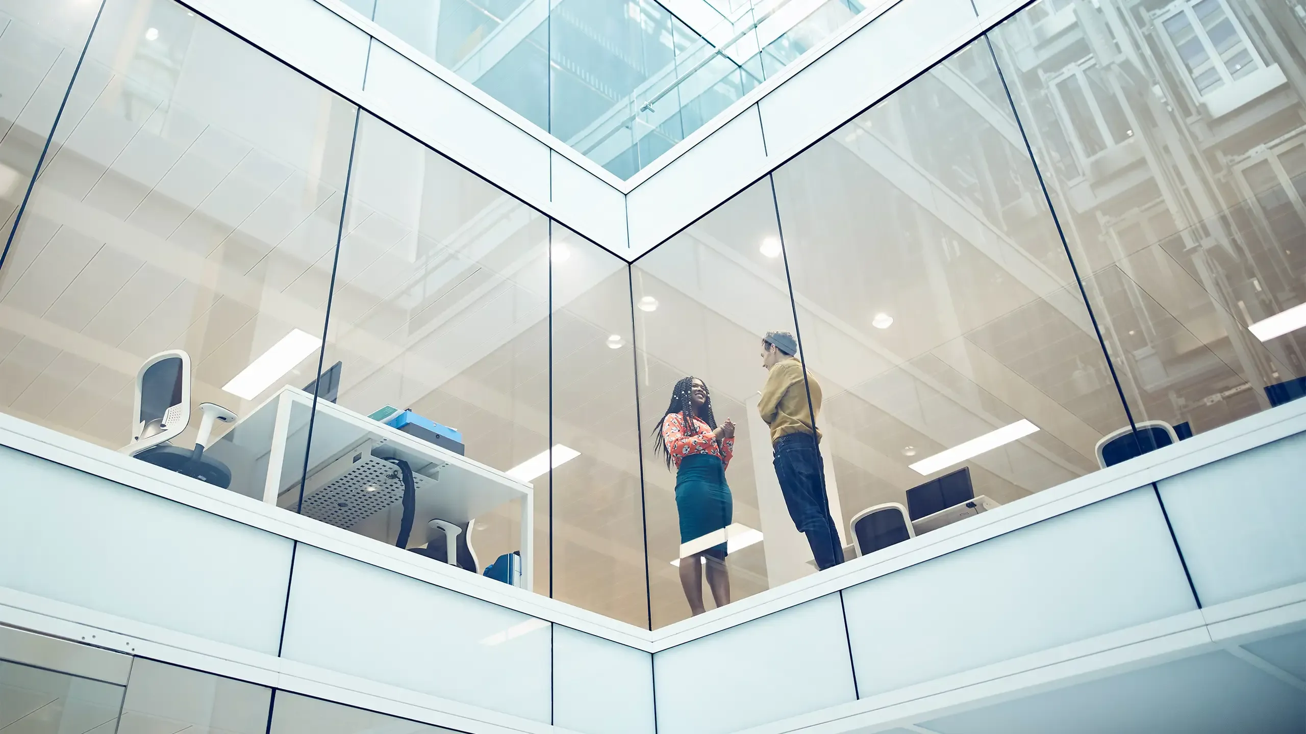 Work colleagues talking in modern office