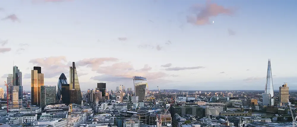 The new constructed skyline of London, United Kingdom, with the modern office buildings of the City until Tower Bridge and Thames river during sunset time