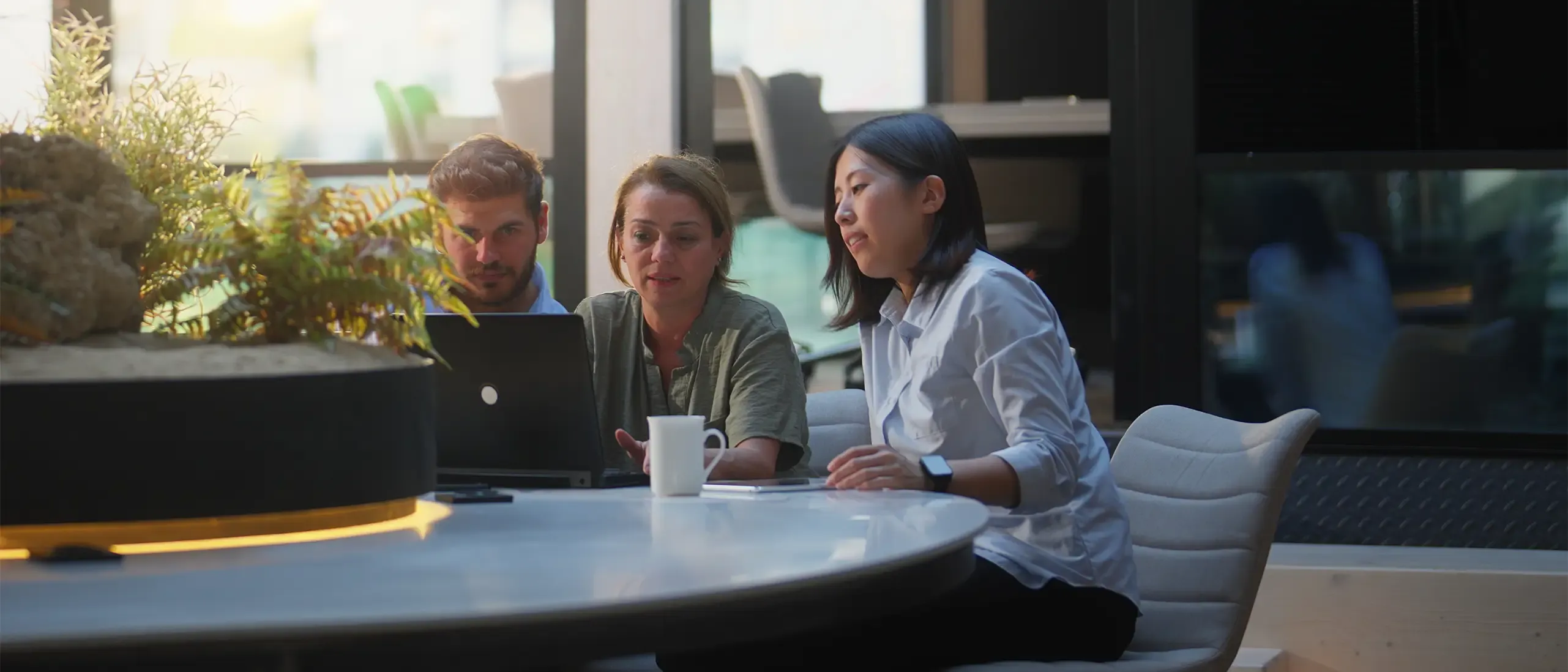 A group of business people are working together in a modern office working space.
