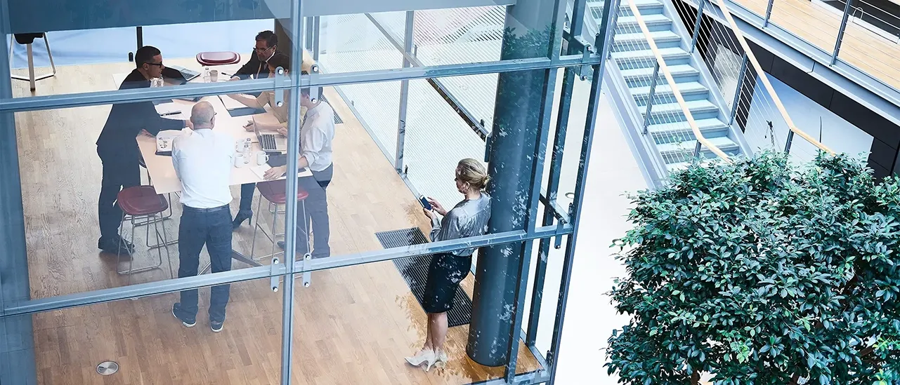 High angle view of businessmen and businesswomen meeting in conference room