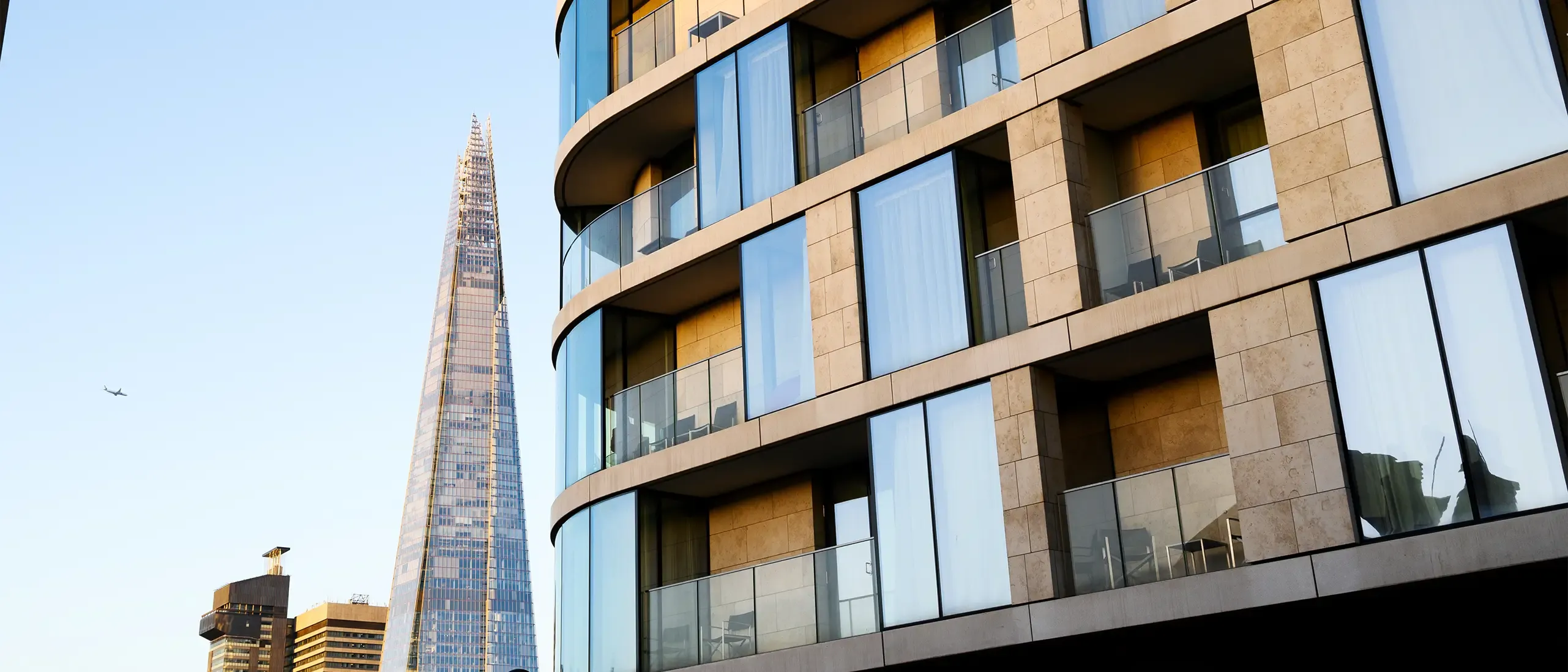 UK, modern contemporary apartment building in central London with view of the Shard at sunrise