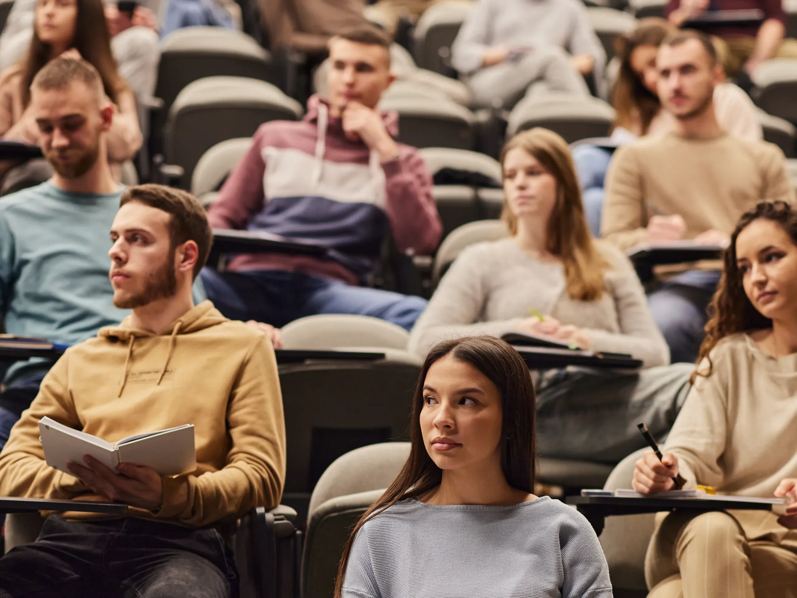 Students sitting in a lecture theatre at university
