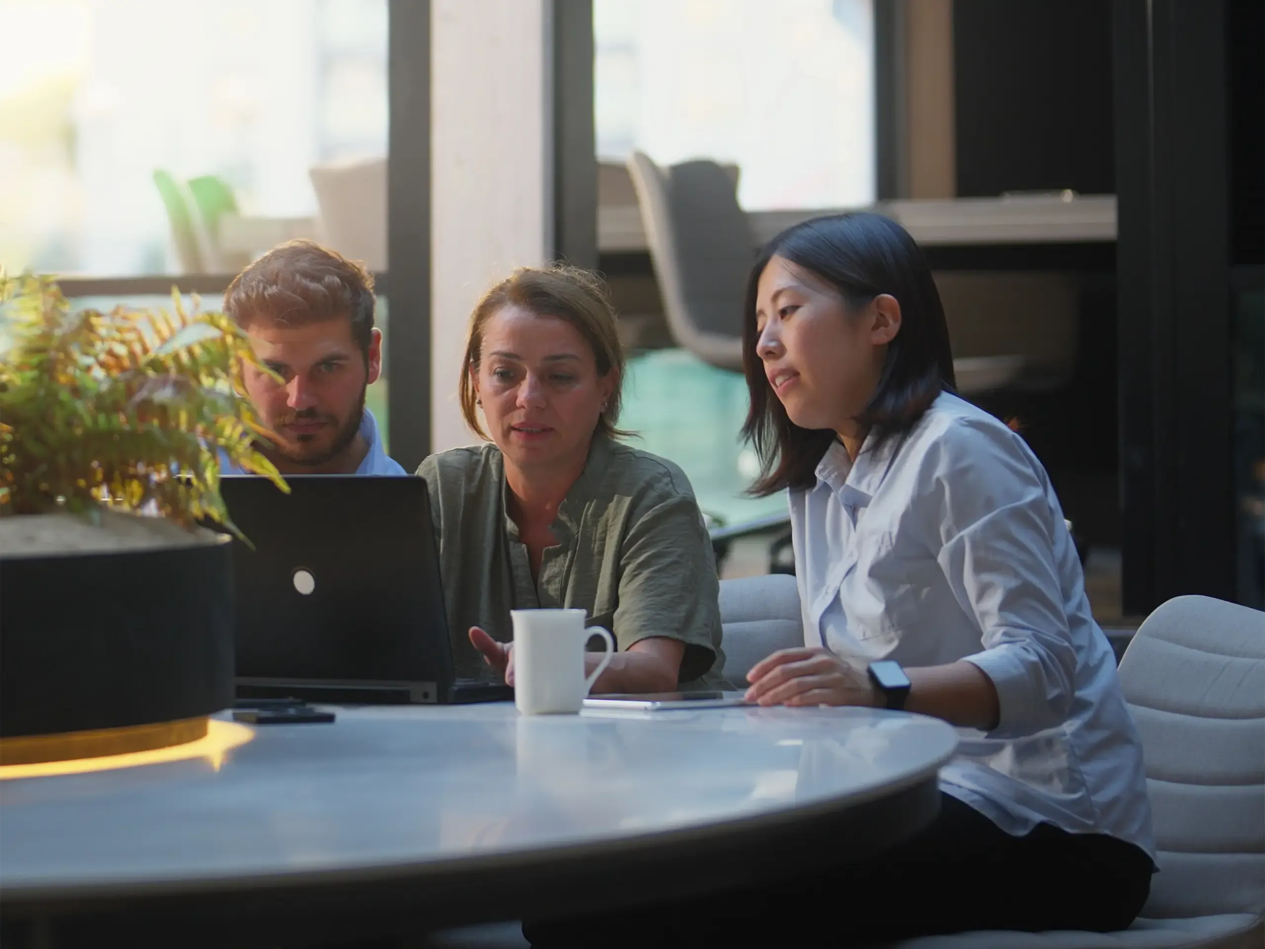 A group of business people are working together in a modern office working space.