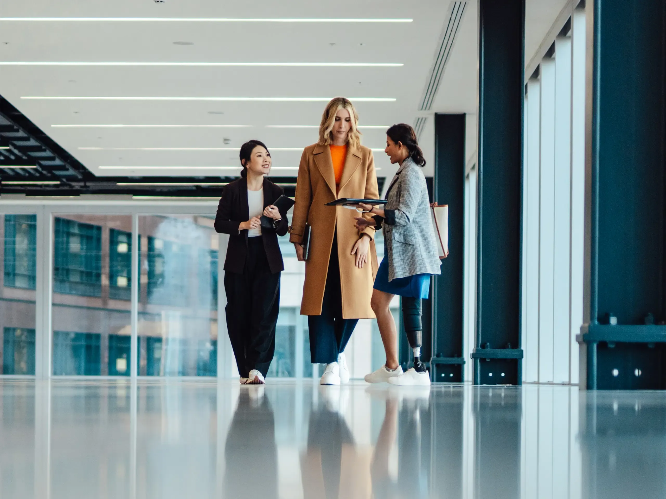 Multi racial group of businesswomen viewing new office space with an estate agent