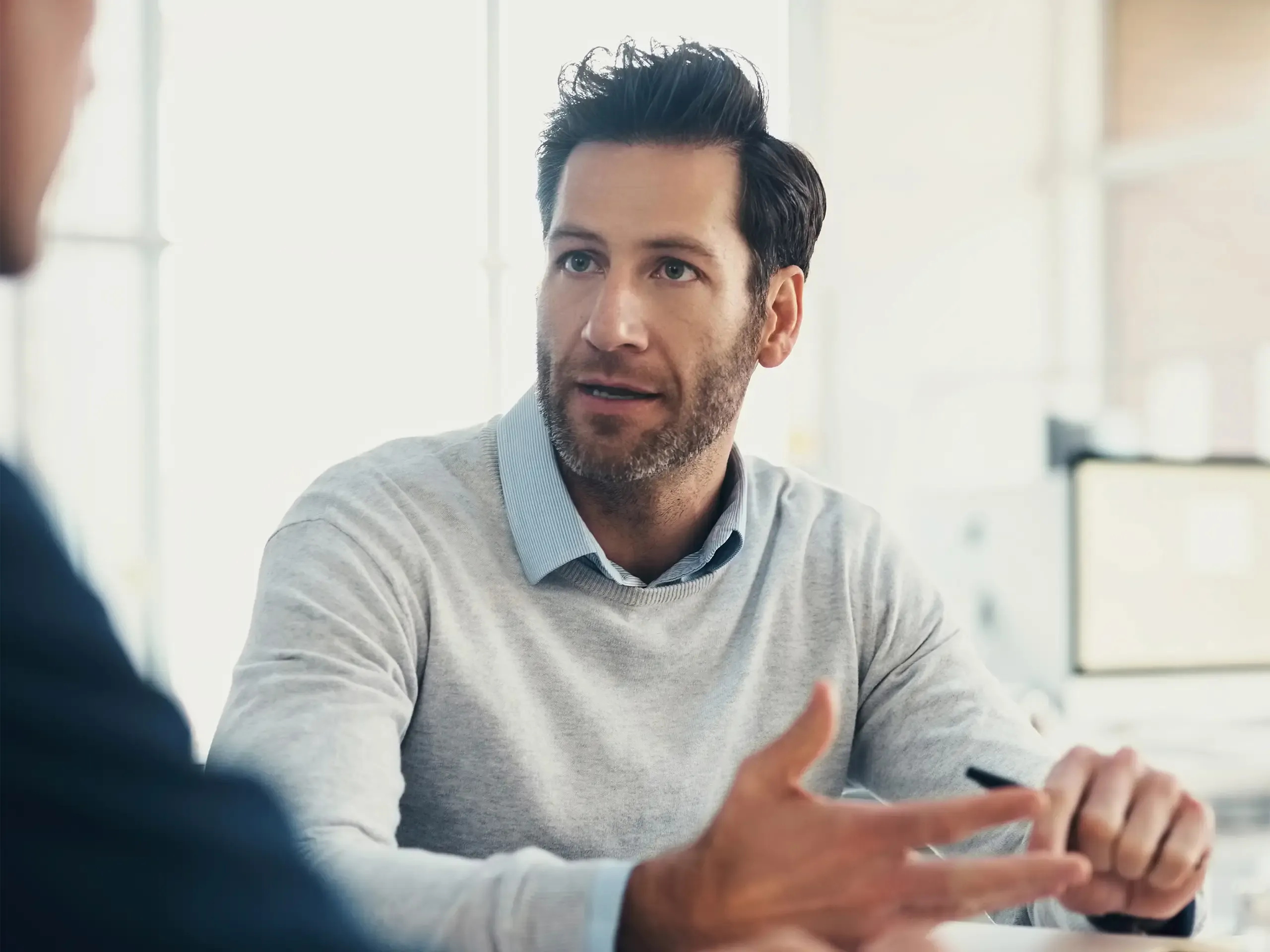 Planning, consulting or business man in meeting with notebook for strategy, analytics research or data analysis. Focus, teamwork or manager for creative idea, company growth or schedule agenda review