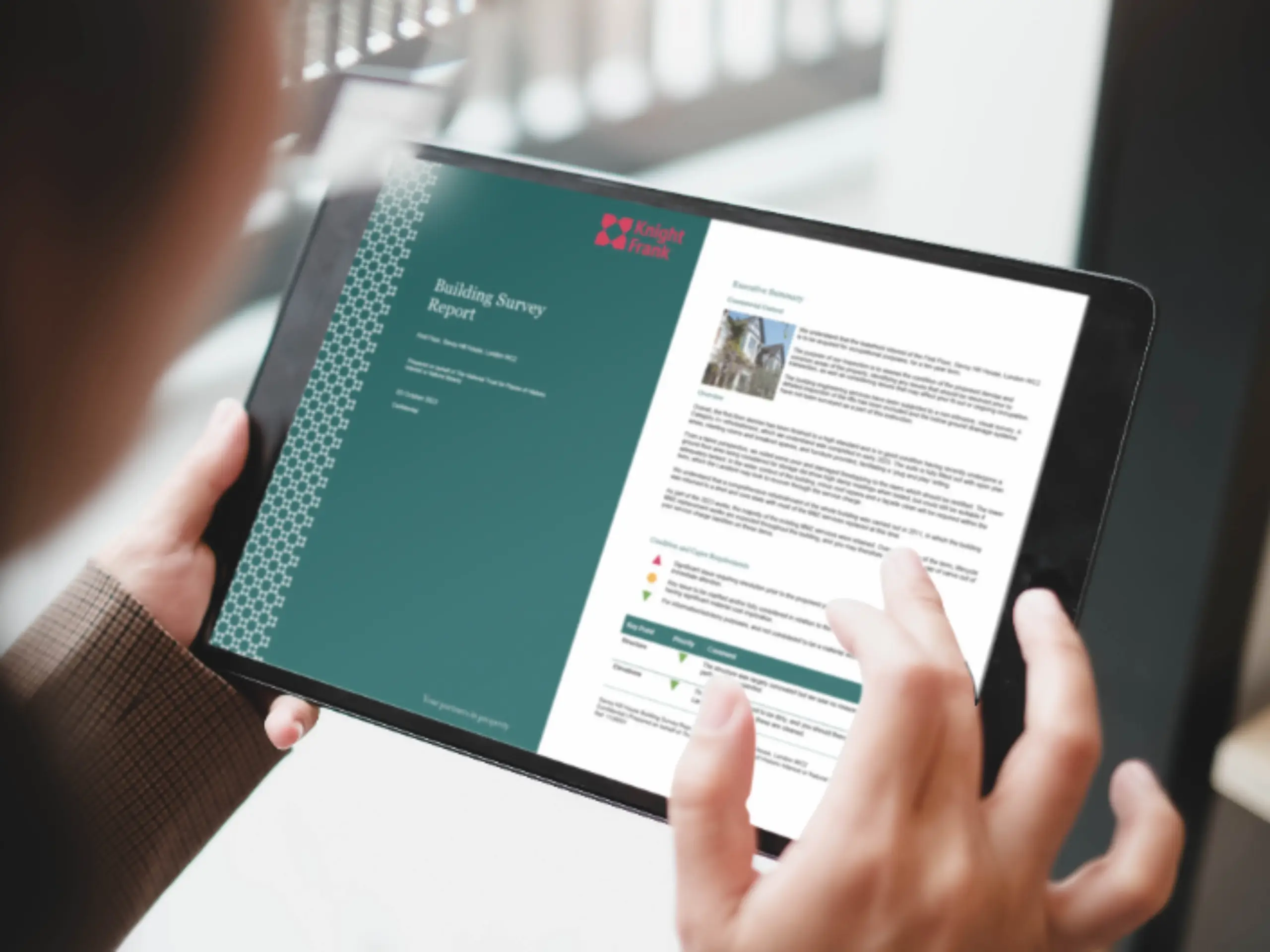 Woman holding tablet, looking at a Knight Frank property acquisition report
