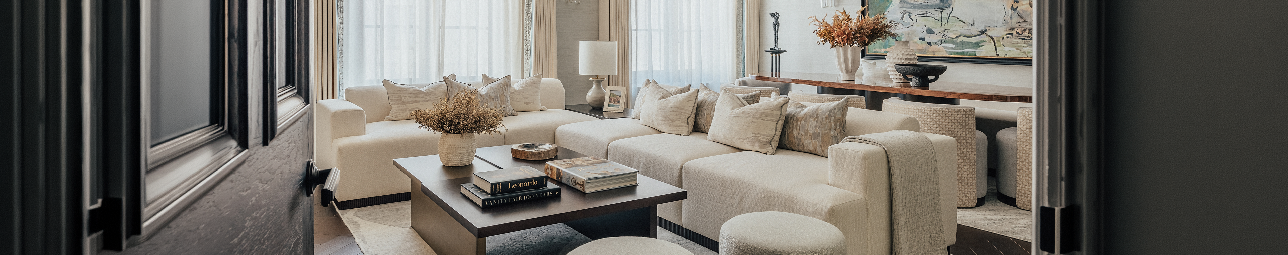 This is a beige corner sofa with a fluted wooden base and modern minimalistic design from the Bazaar London collection.