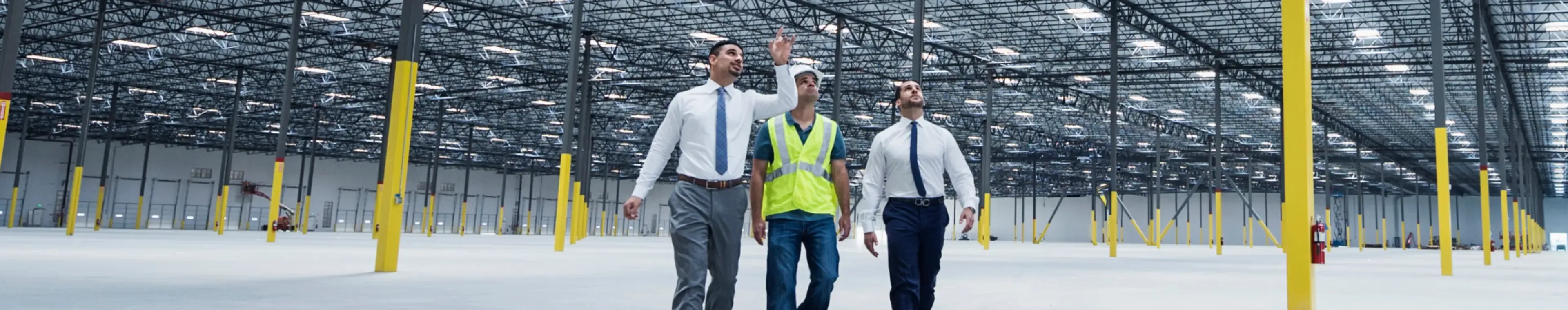 Businessmen walking and talking in empty warehouse