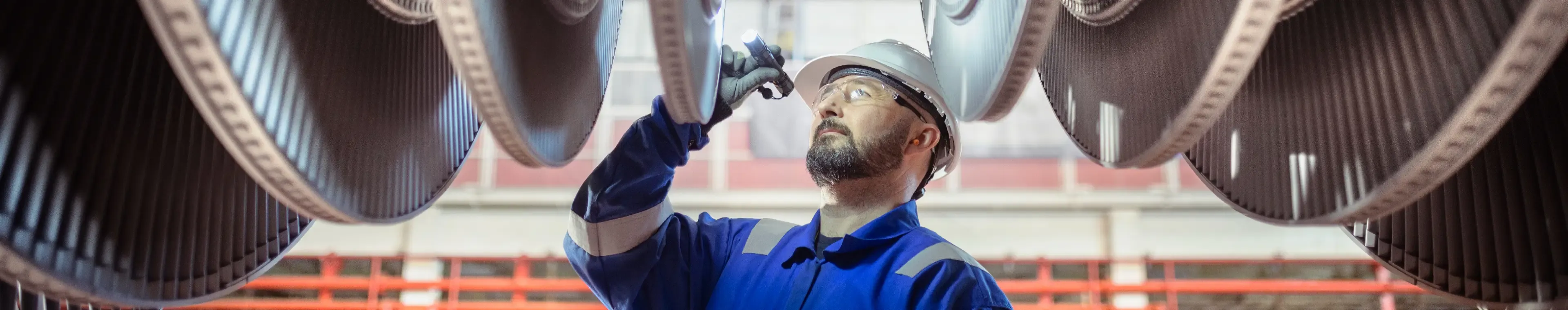 Engineer inspecting a turbine in a nuclear power station.