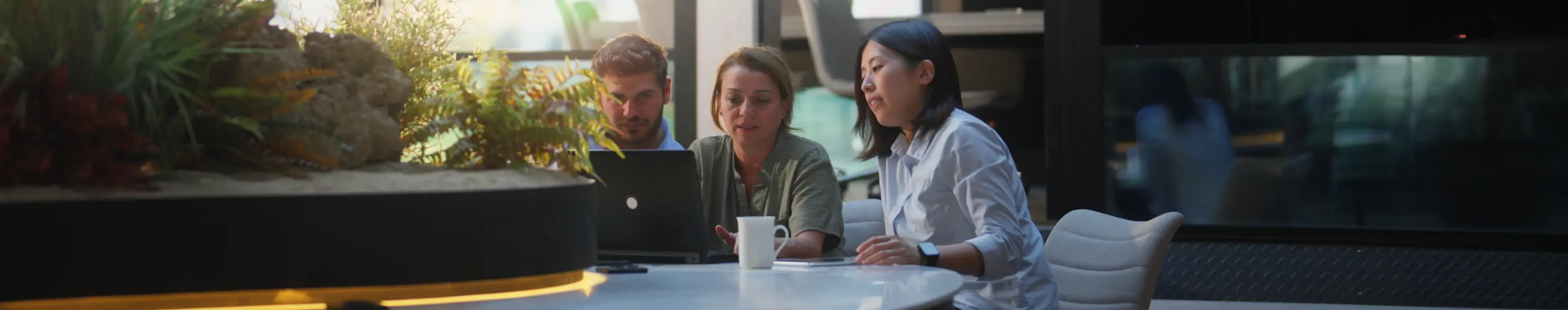 A group of business people are working together in a modern office working space.