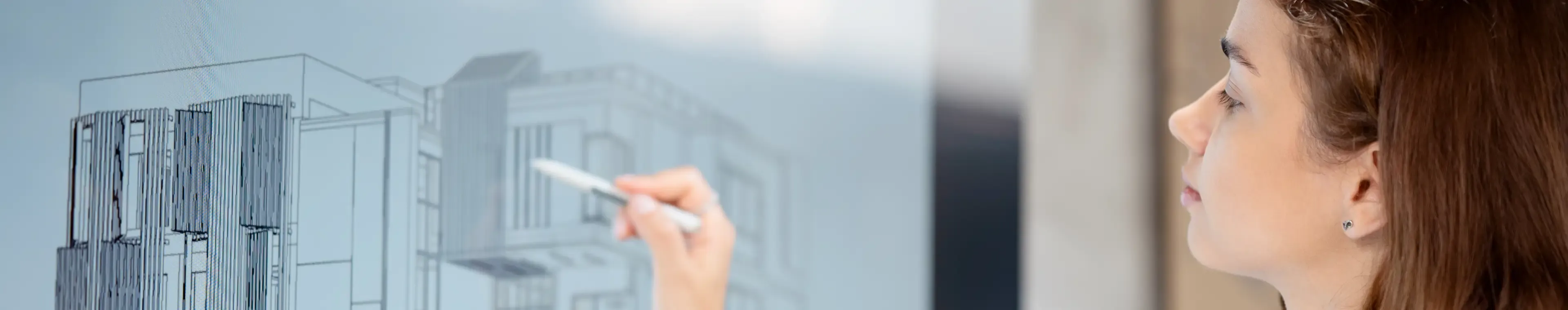 A female architect is drawing on a whiteboard as part of a real estate construction project.