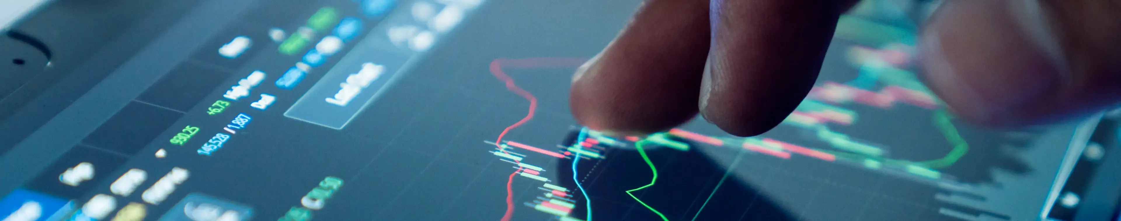 Market analyse with digital monitor focus on tip of finger