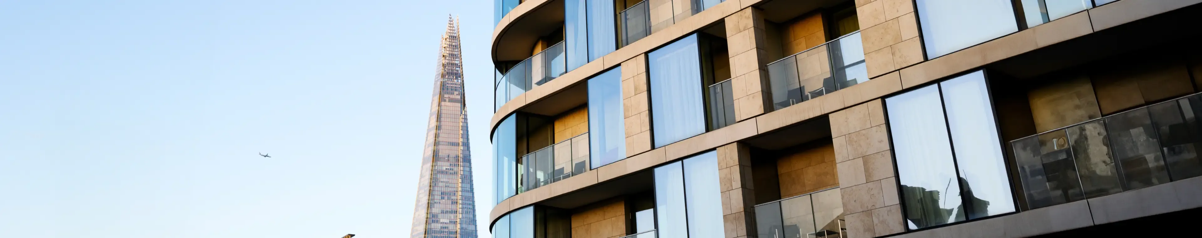 UK, modern contemporary apartment building in central London with view of the Shard at sunrise