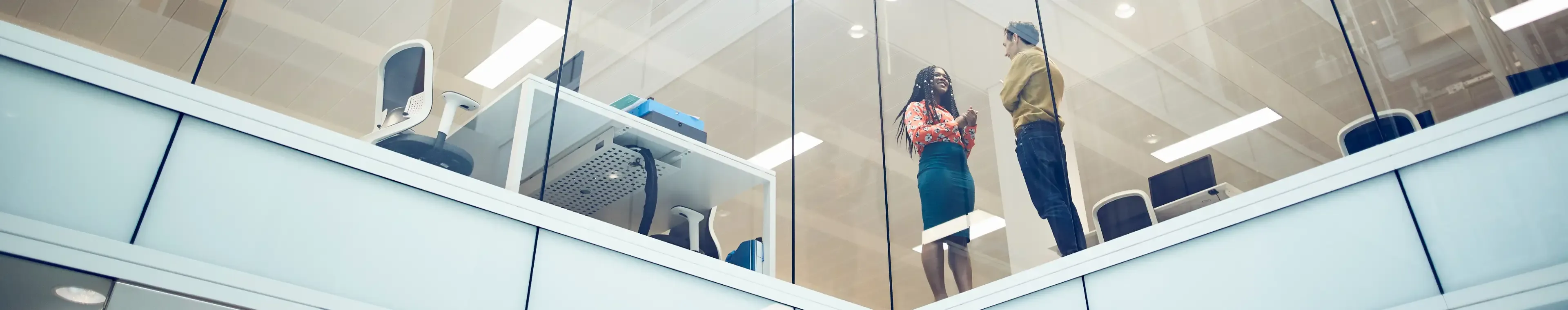 Work colleagues talking in modern office