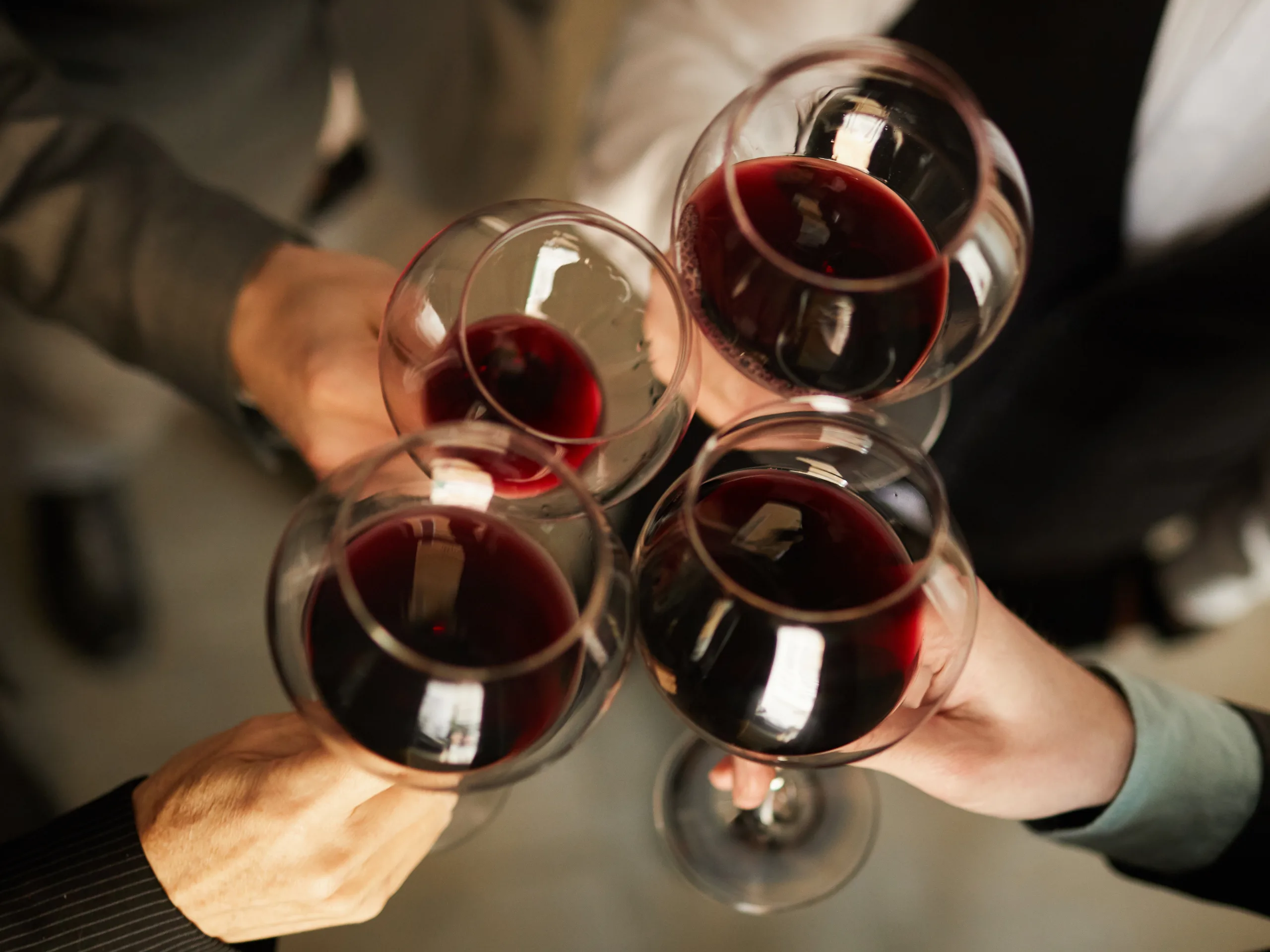 Business people drinking wine photographed from above
