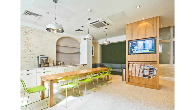 Green Park House's vibrant kitchen with bright green chairs