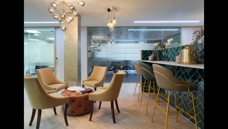 13 Hanover Square's breakout space with beautiful green sofas